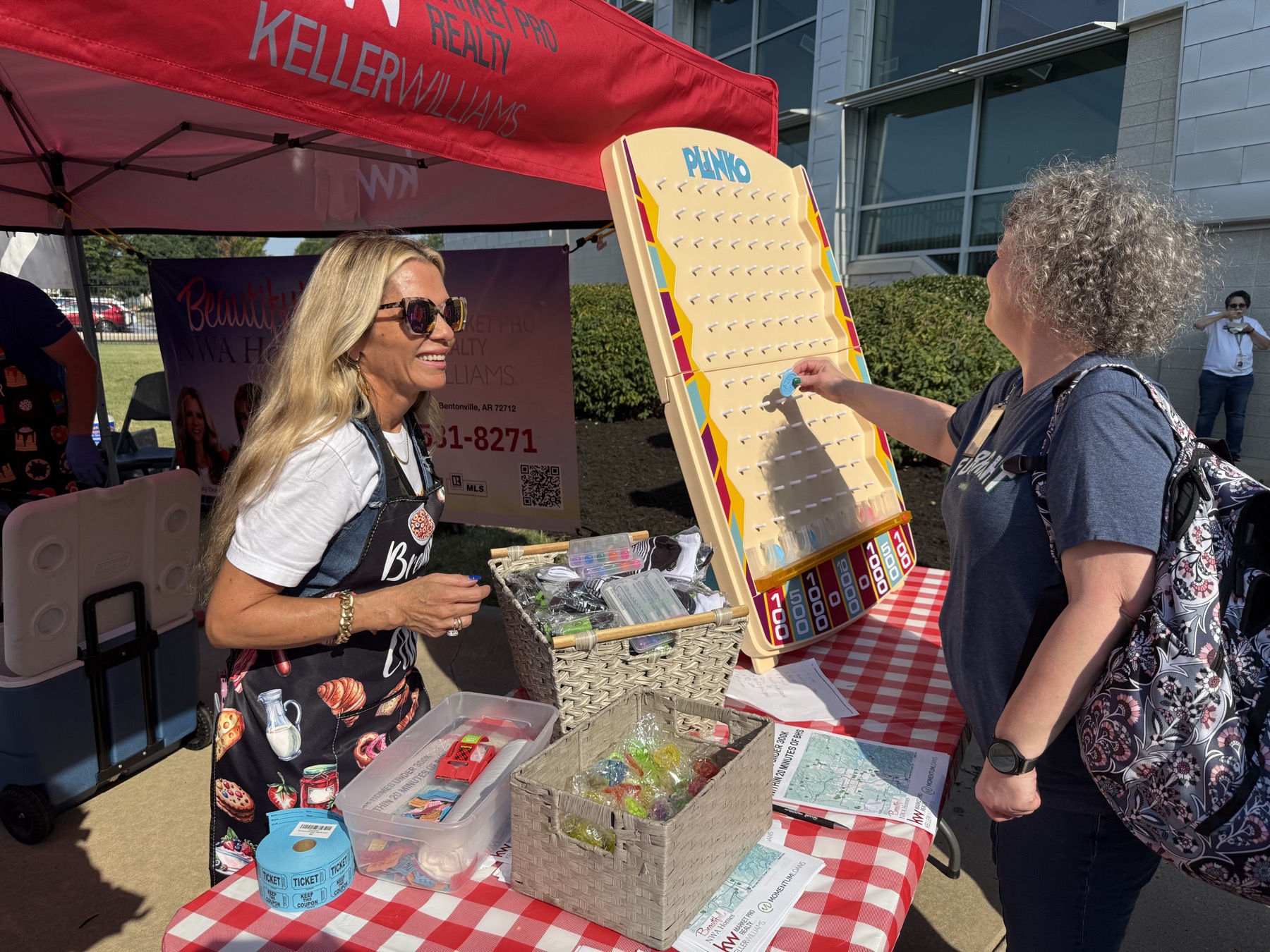 Nancy Orum talking with neighbours at a community booth